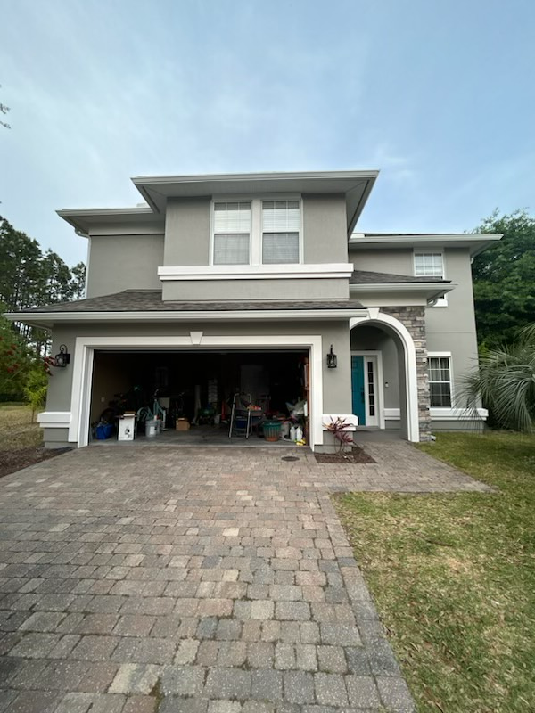a large house with a garage and a driveway in front of it