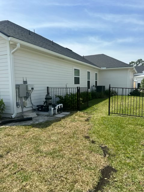 a white house with a fence in front of it