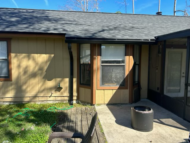 a house with a screened in porch and a window