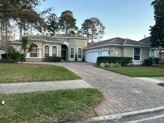 a house with a brick driveway leading to it