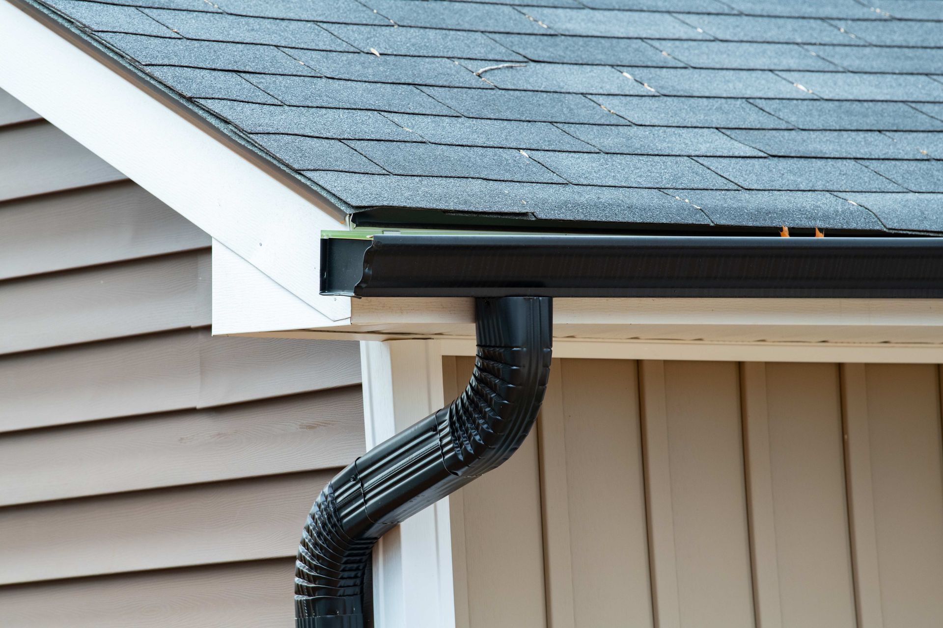 a close up of a gutter on the side of a house