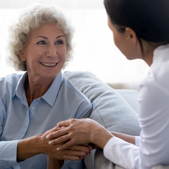 Senior Lady Holding Hands With Caregiver — Memory Care — Assured Senior Living