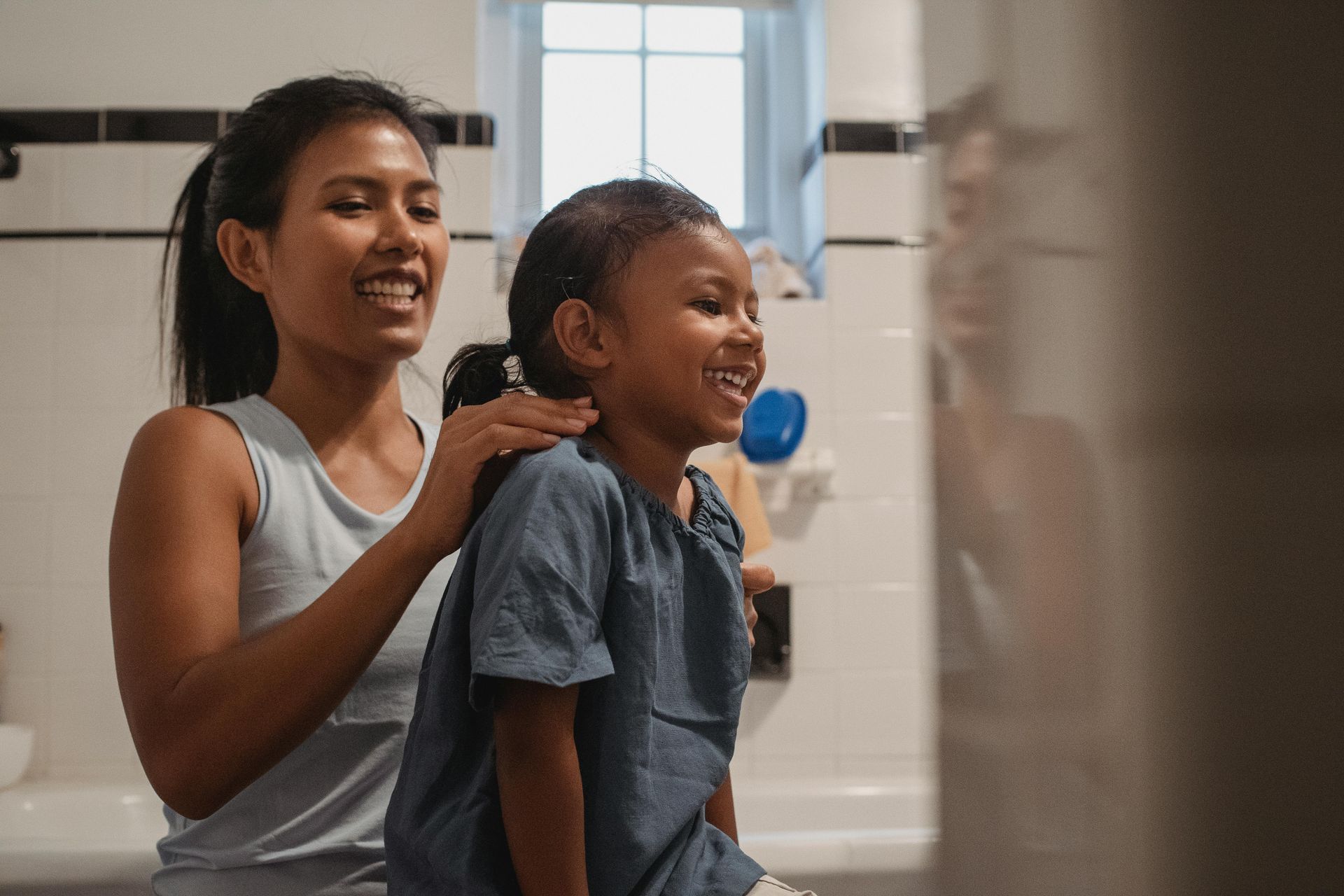A mother and daughter in a bathroom