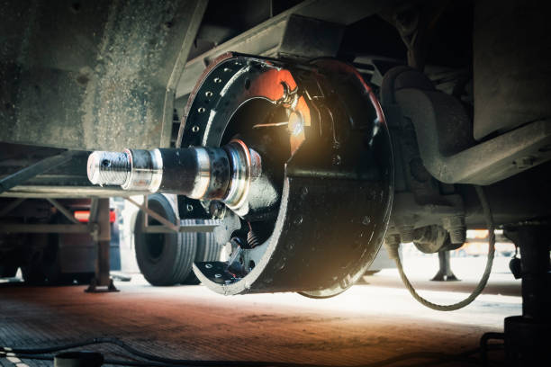 A close up of a wheel on a truck being worked on.