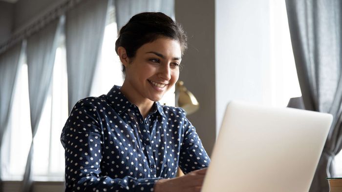 smiling woman using a laptop