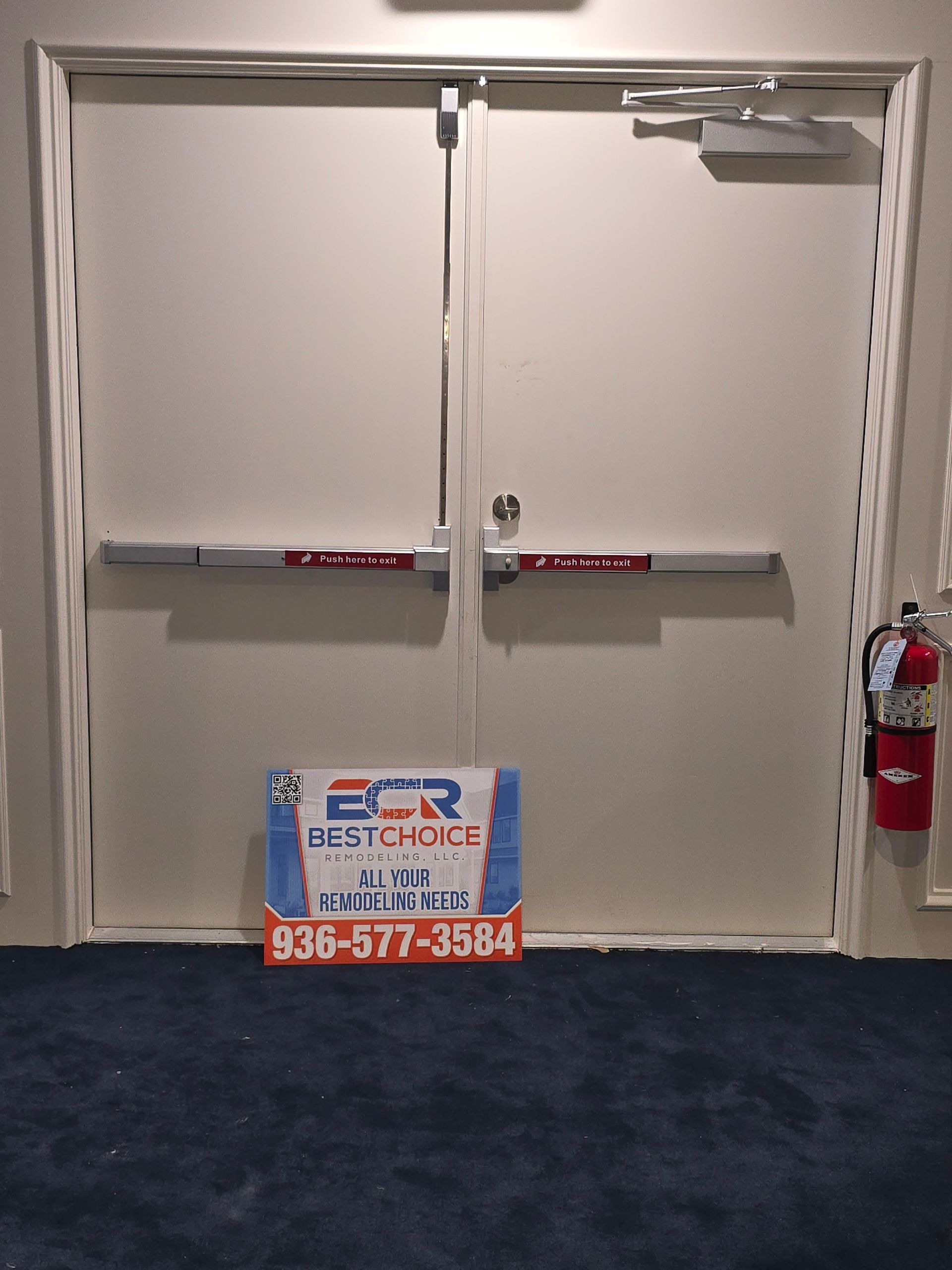 A white door with a fire extinguisher next to it