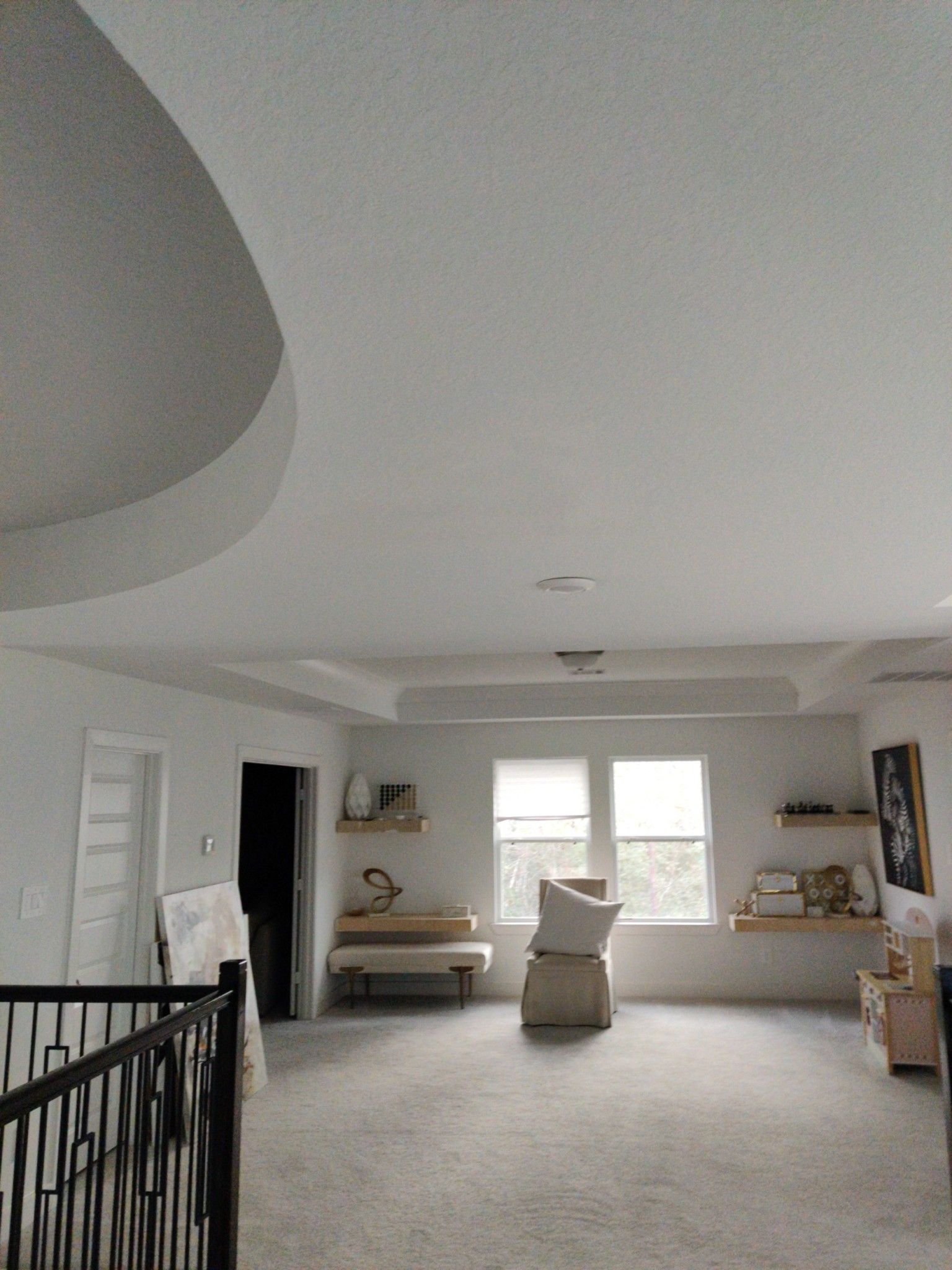 A living room with a staircase leading to the second floor