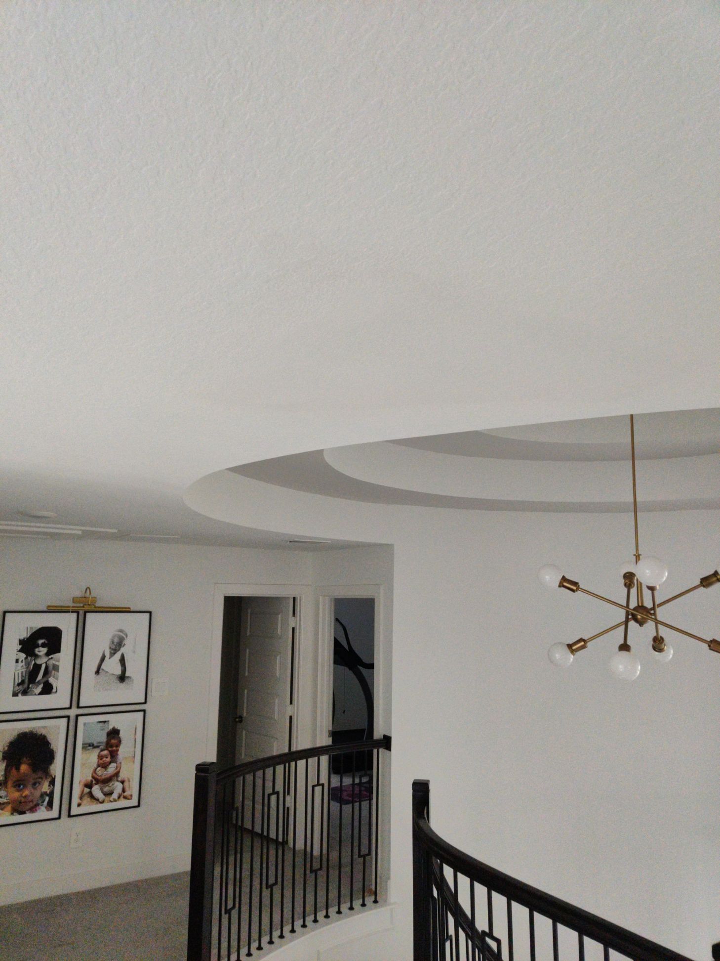 A room with a chandelier hanging from the ceiling