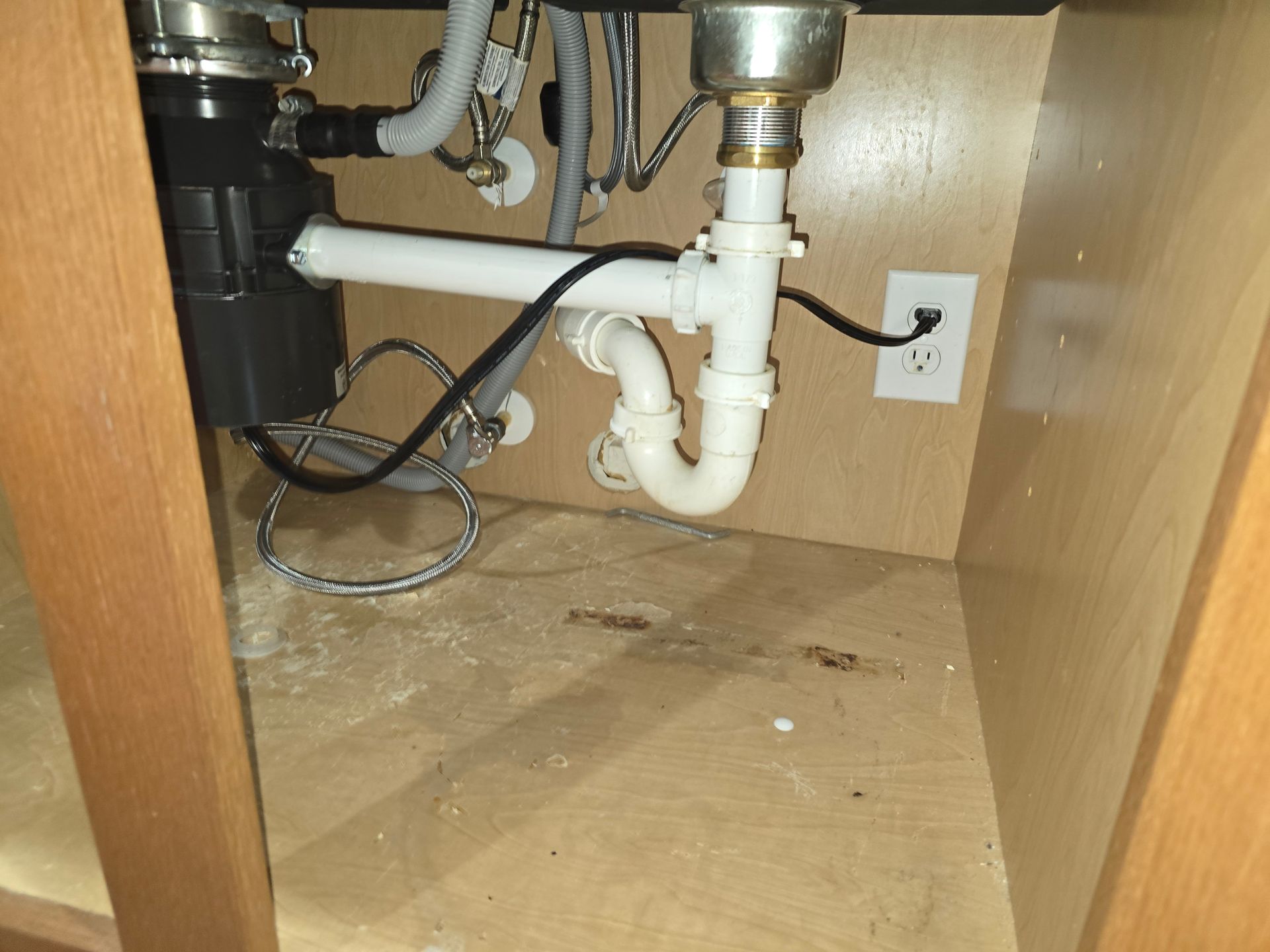A sink with a garbage disposal underneath it