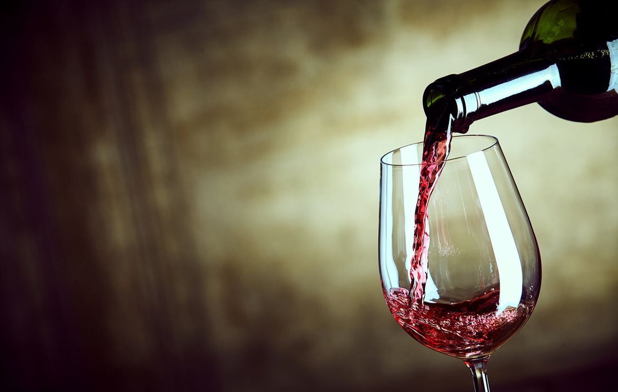 wine being poured into a glass