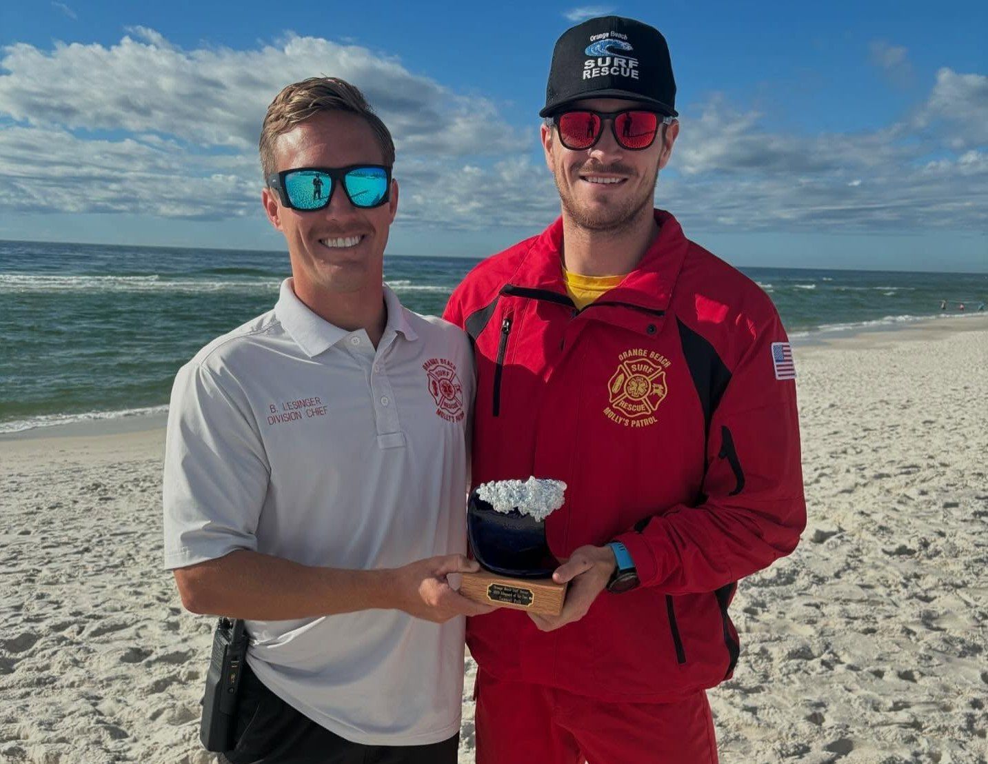 Beach Safety Division Chief Brett Lesinger presenting Lifeguard of the Year award to Samuel Pelt