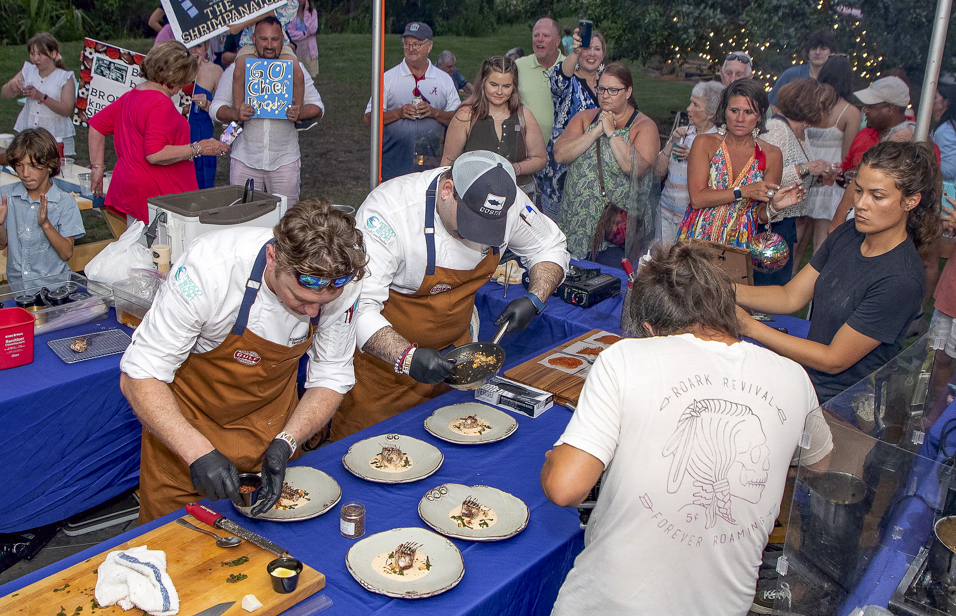 Chef Brody Olive and sous chef Luis Silvestre put the finishing touches to their winning dish at the 2023 Alabama Seafood Cook-Off. Photo by Billy Pope