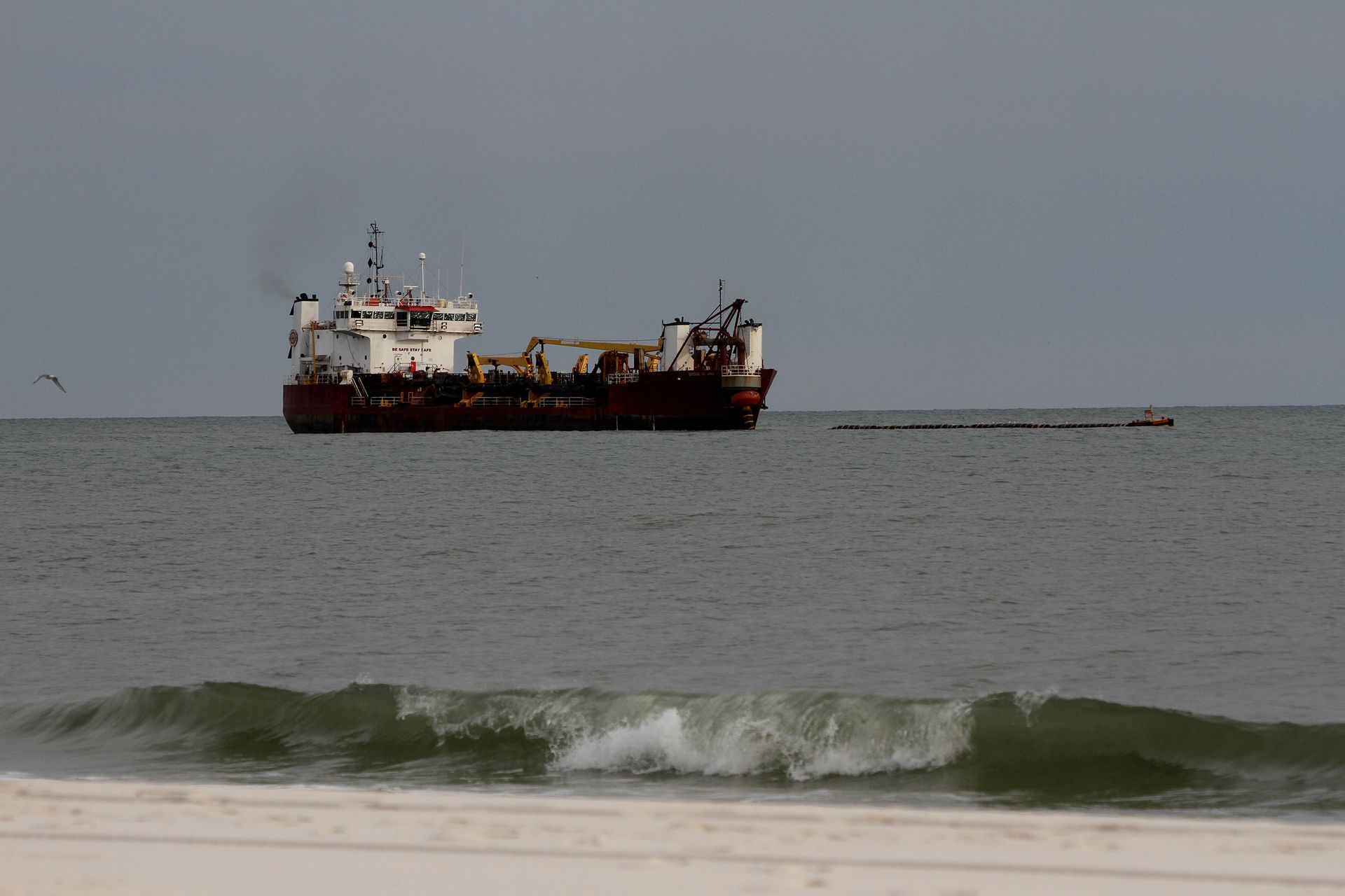 The dredge ship takes sand from areas just off the shoreline and pumps it onto the beach via a pipeline. Photo by David Rainer