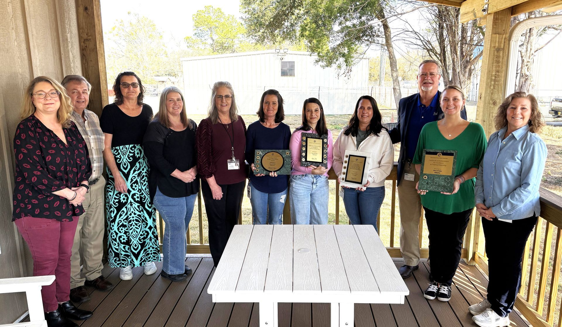 Foley Finance Department employees and city officials commemorate receiving the “triple crown