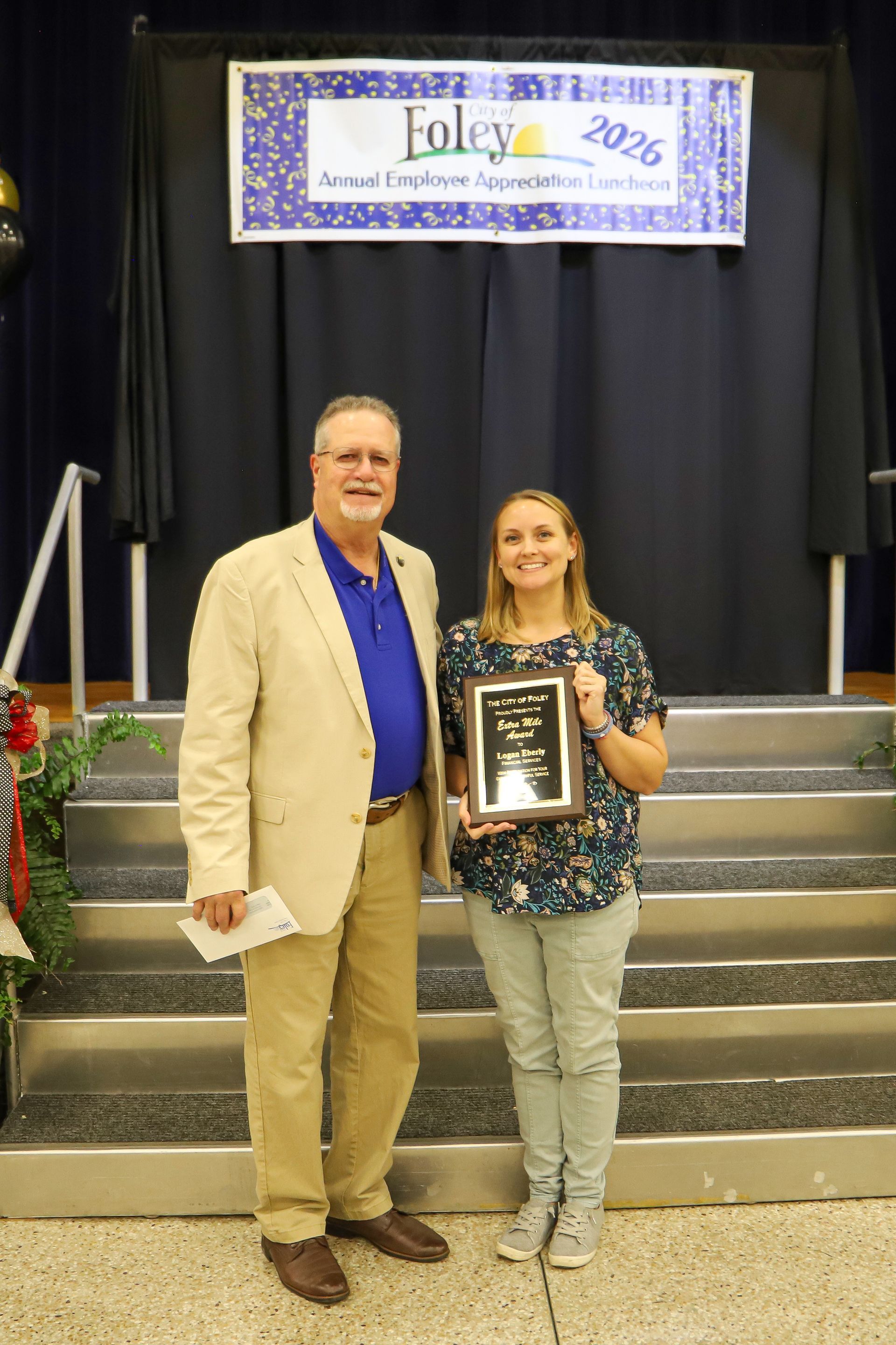 Ralph Hellmich presents the Foley Extra Mile Award to Logan Eberly, city
grants and special agreement administrator, during the city’s Employee Appreciation Event on
Thursday, March 6.