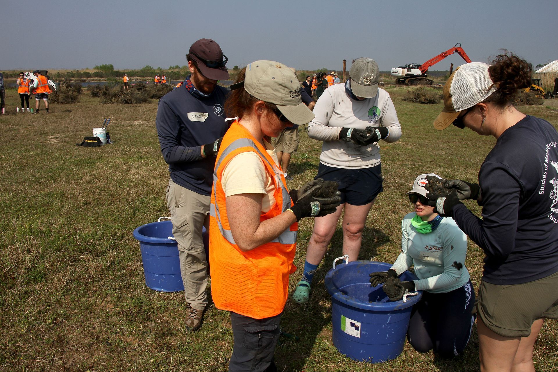 Volunteers and marine science students sort through oysters to be replanted near Bayou La Batre. Photo by David Rainer
