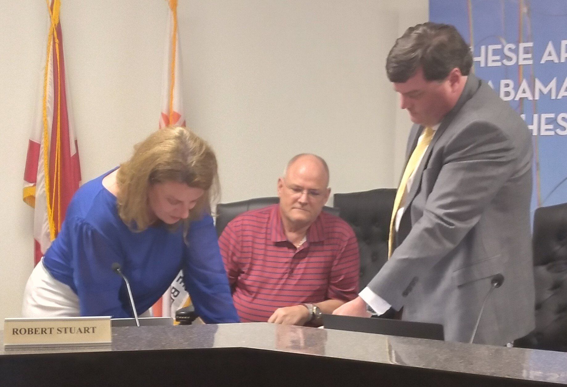 Interim Superintendent Dr. Robbie Smith, right, signs Orange Beach/Baldwin County separation papers.