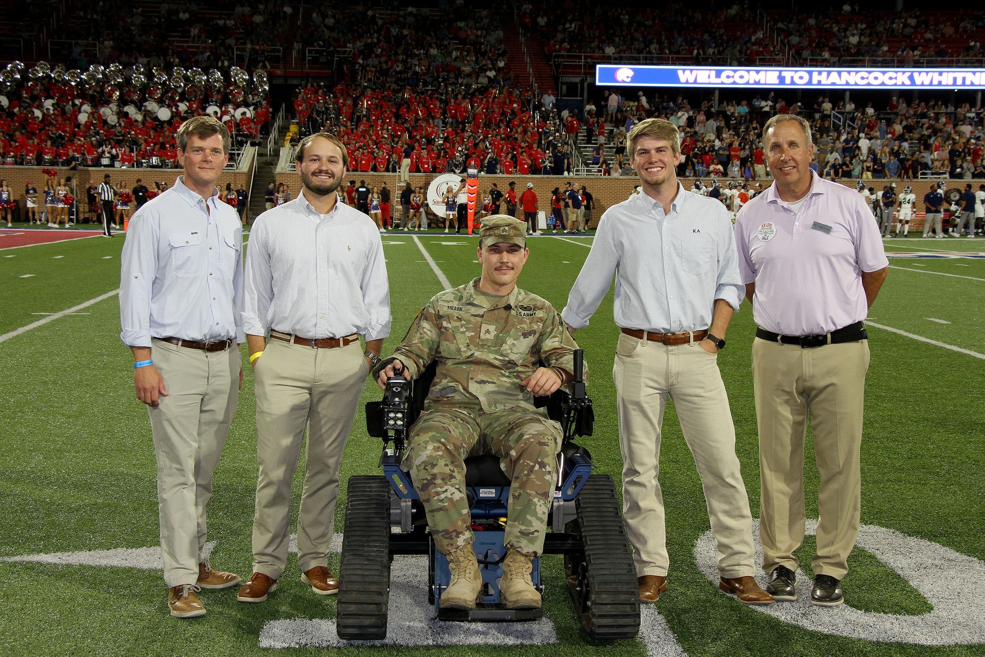 During the USA Jaguars football game, the KA fraternity at the university donated the track chair to Alabama State Parks. Celebrating the event are, from left, State Parks Director Matthew Capps, KA's Hunter Fairchild. Justin Miller and Luke Sparkman, and ADCNR Deputy Commissioner Ed Poolos. Photo by David Rainer