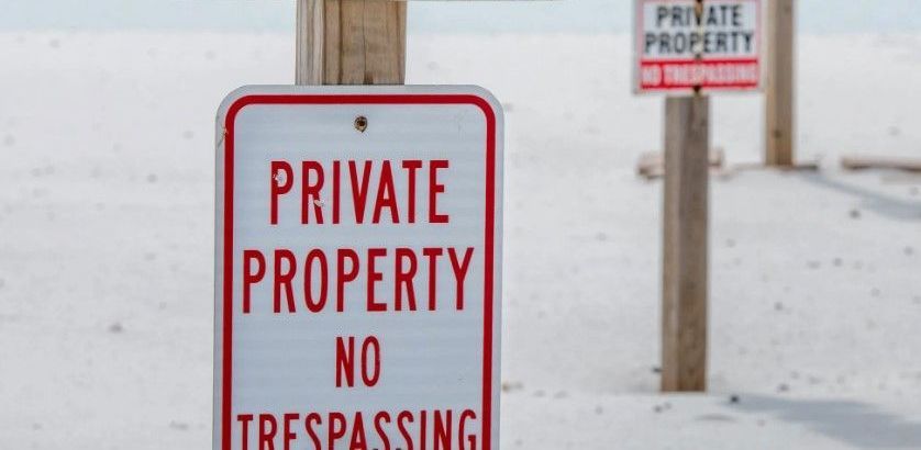 These signs illegally claim private Gulf beaches County Commissioner Jeff Bergosh says.