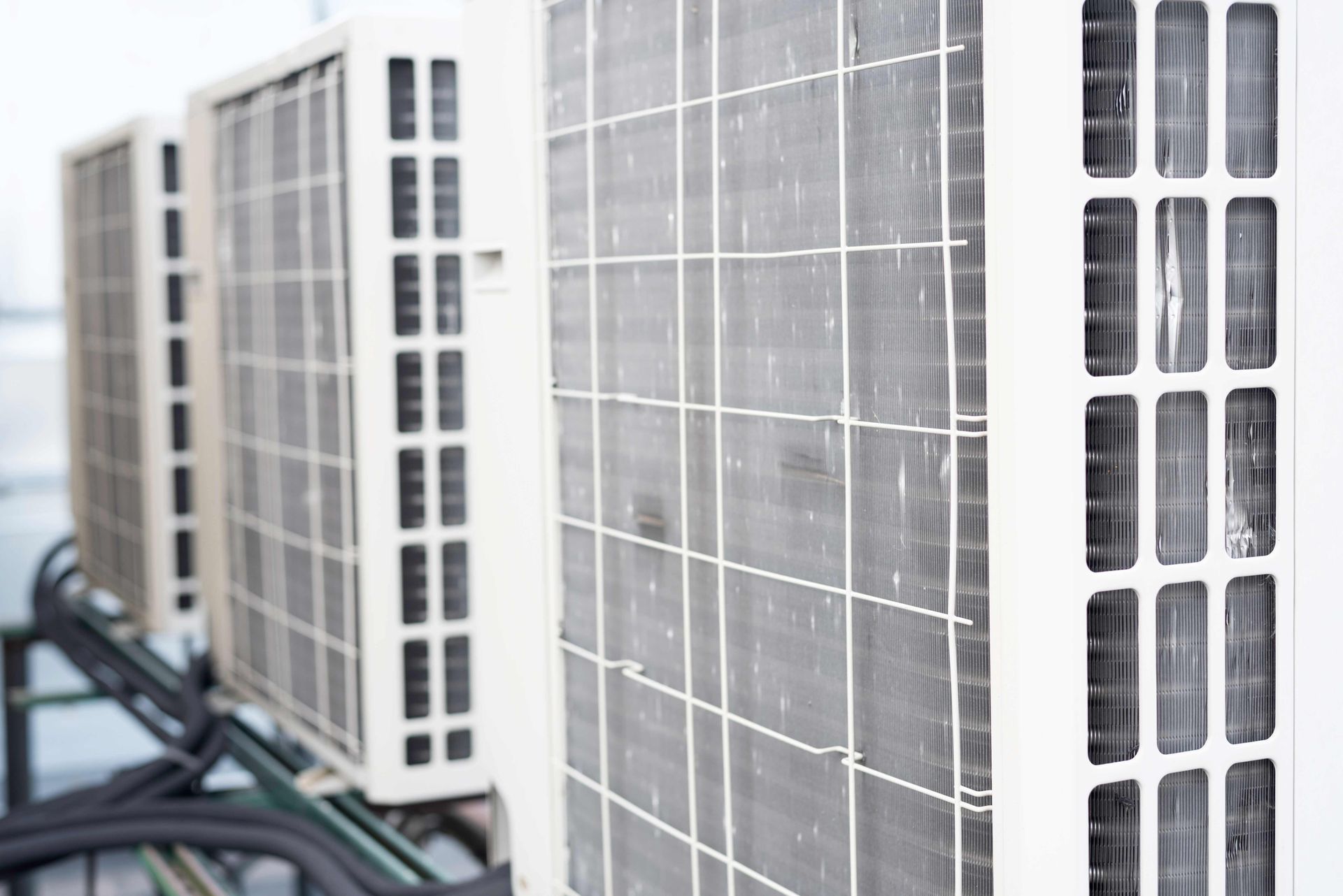 Row of white outdoor air conditioning units.