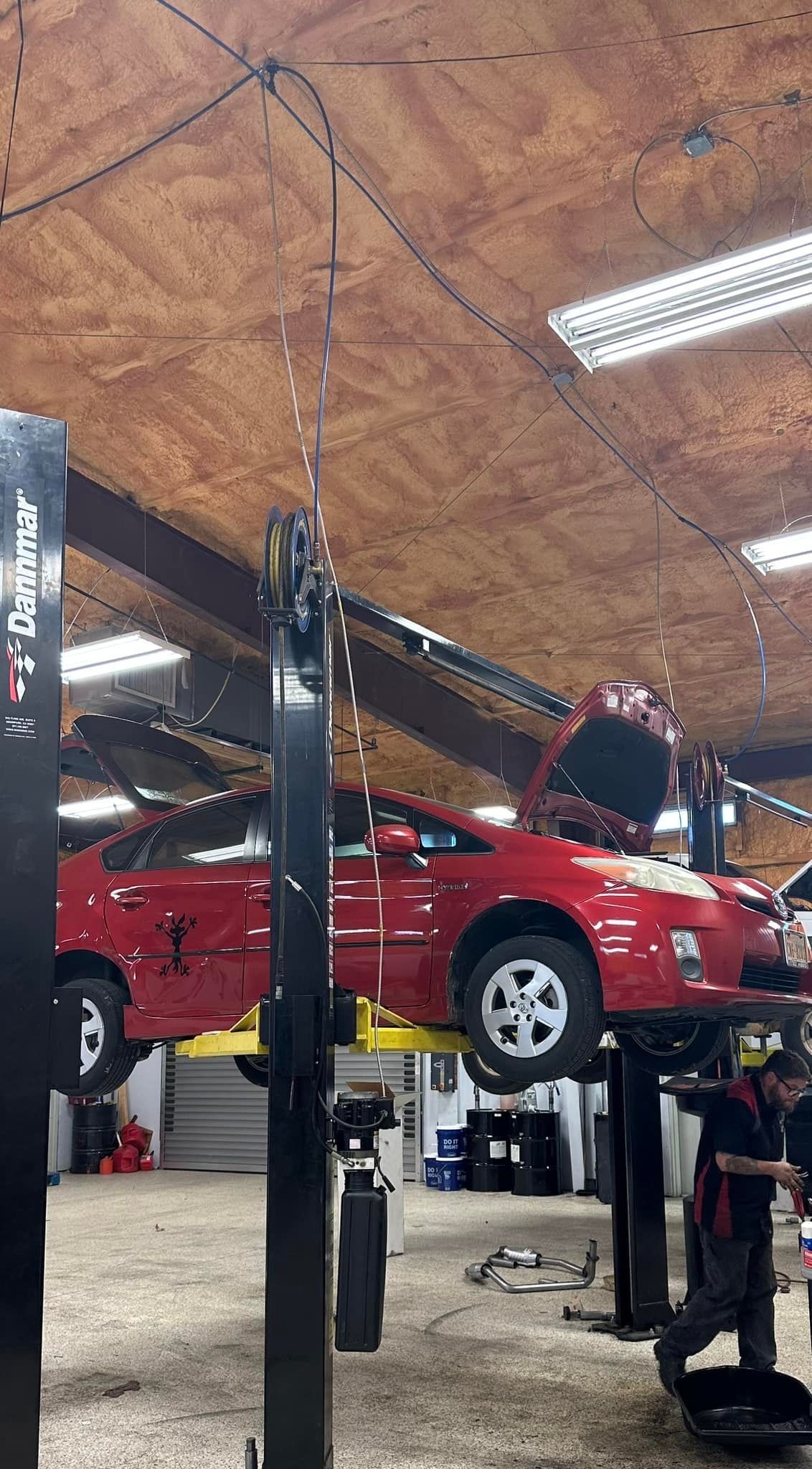 Red Car on a Lift | Premier Auto Repair