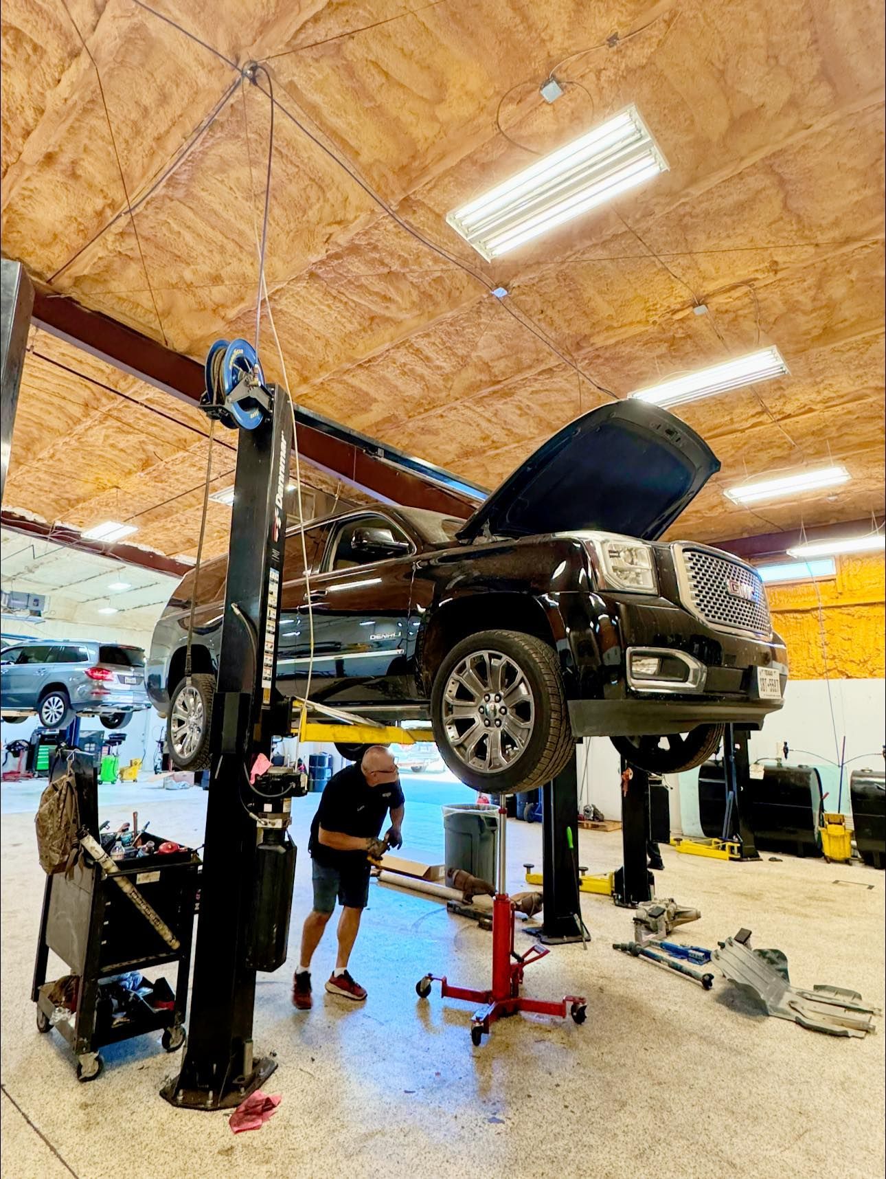 Mechanic Working on a Black SUV | Premier Auto Repair