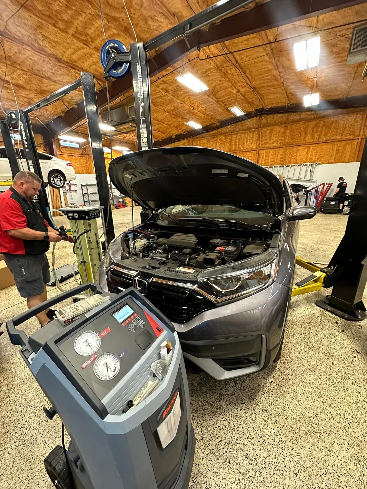Mechanic Working on a Car's Engine | Premier Auto Repair