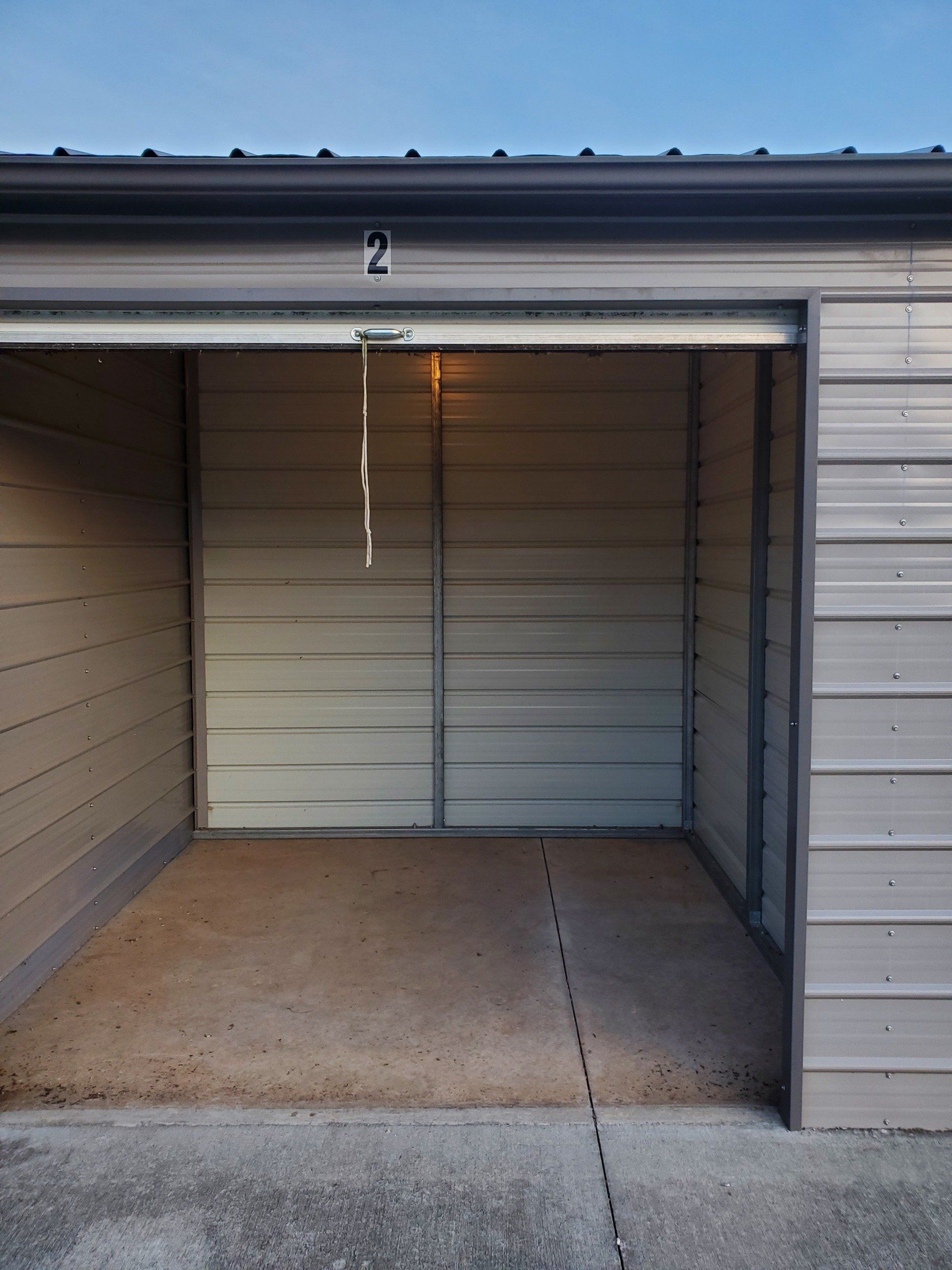 An empty garage with the number 2 on the door