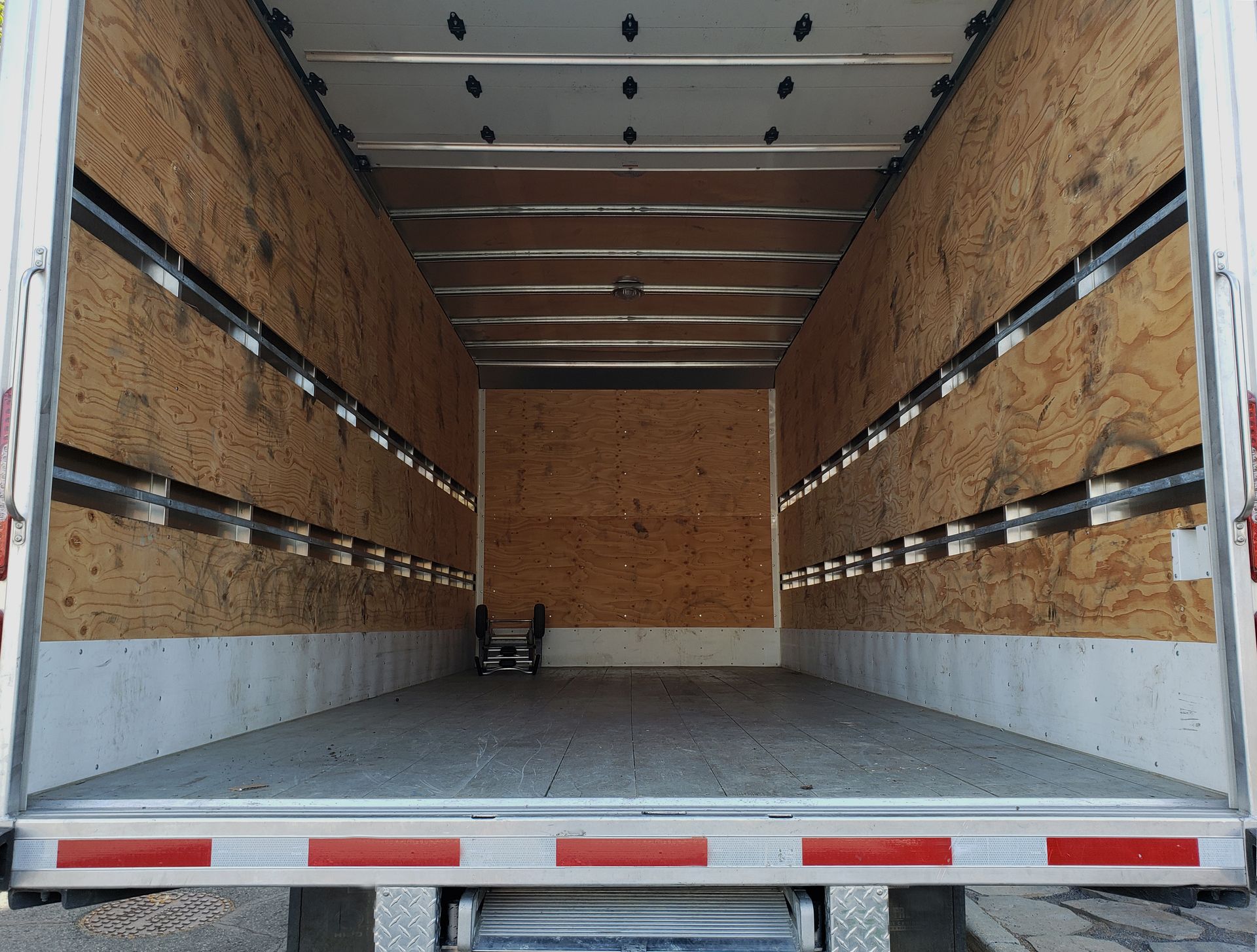 The inside of an empty truck with the doors open