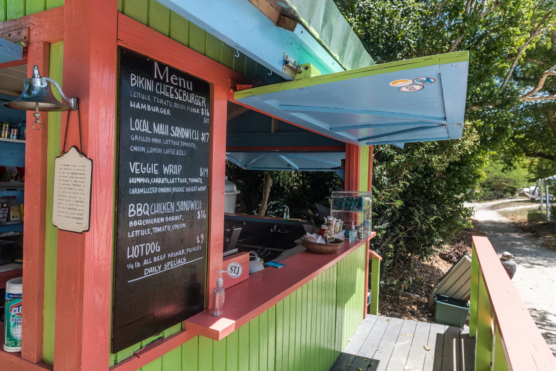 A colorful wooden kiosk with a menu on it