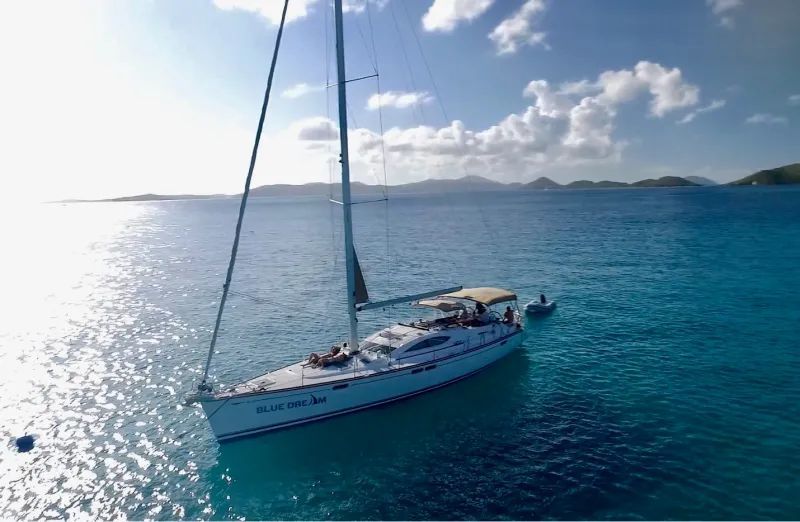 A sailboat is floating on top of a body of water