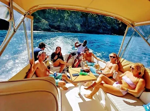 A group of people are sitting on a boat in the water