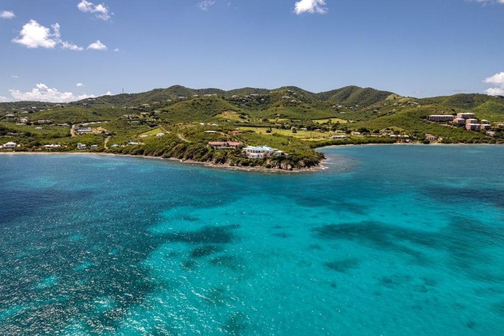 An aerial view of a large body of water with mountains in the background.