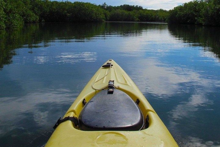A yellow kayak is floating on a river