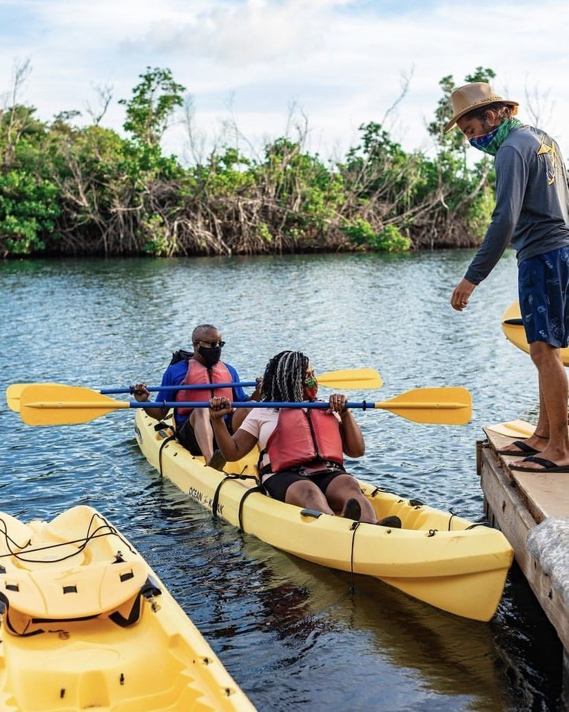 A group of people are in yellow kayaks on a river.