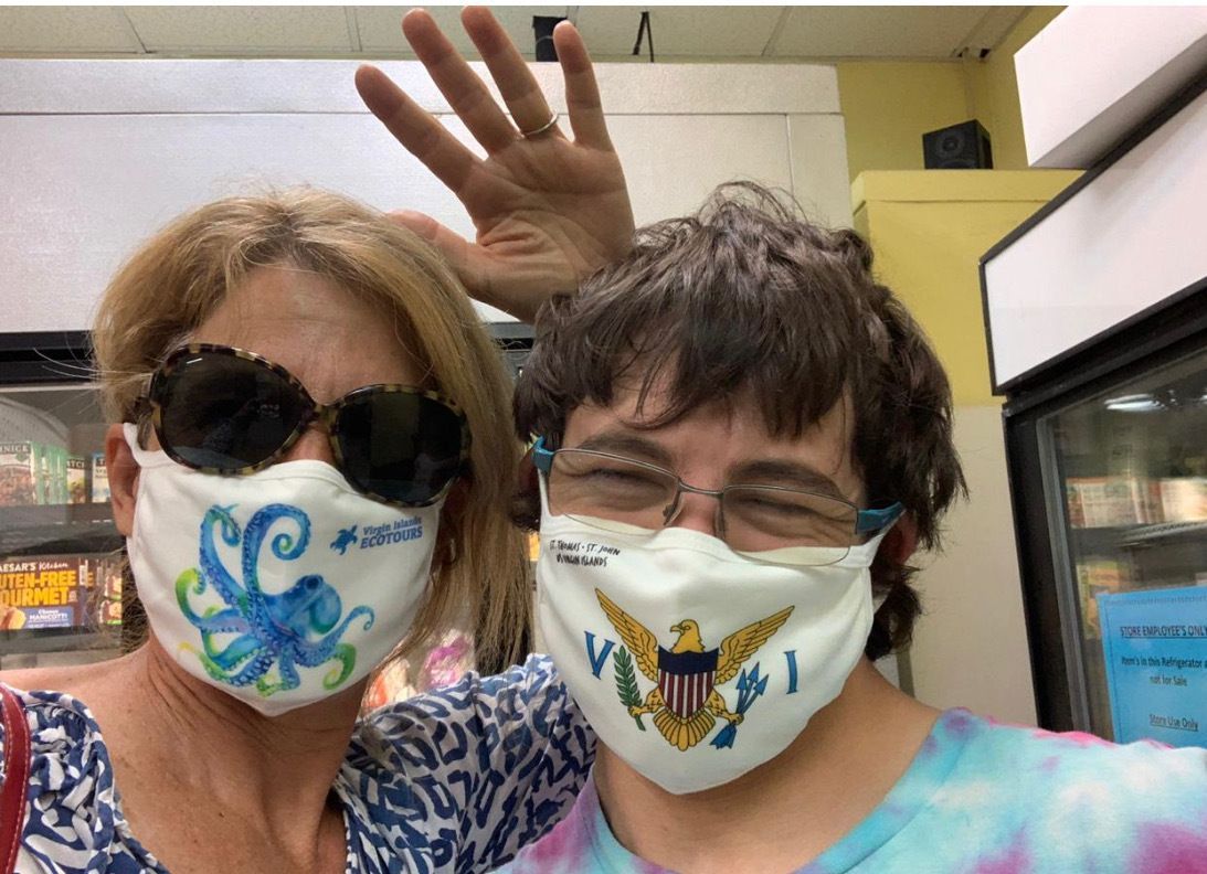 A man and a woman wearing face masks in a store