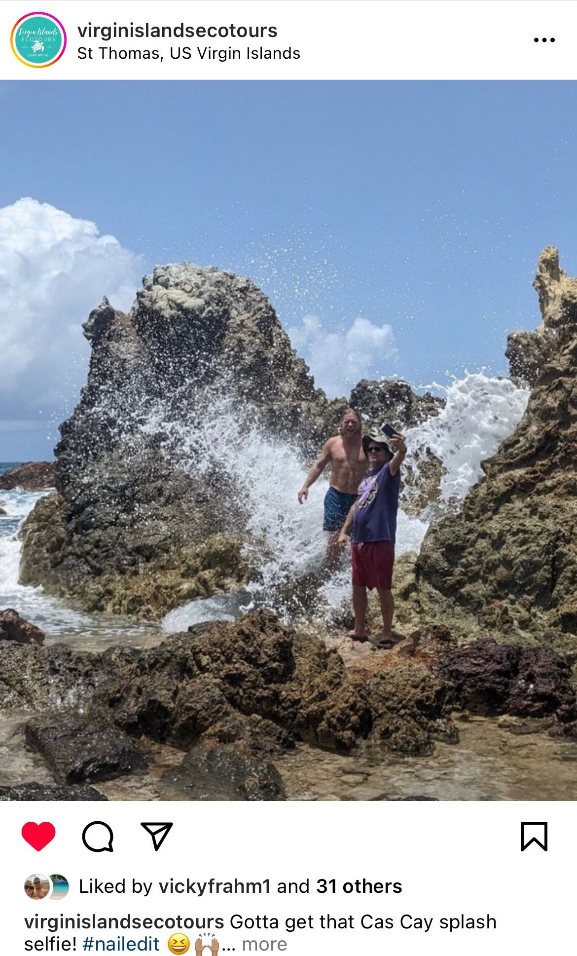 A couple of men standing on top of a rocky beach.