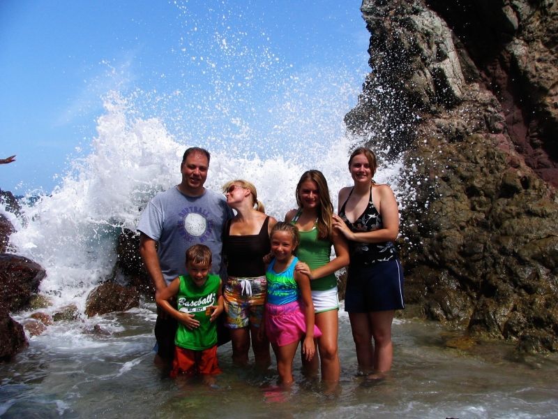 A family posing for a picture in the ocean