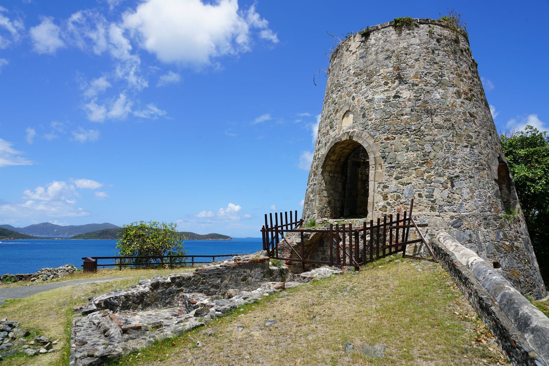 An old stone building along the blue sea