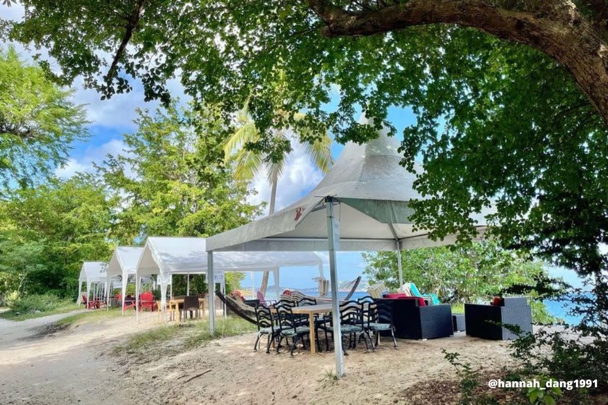 A tent with a table and chairs underneath it