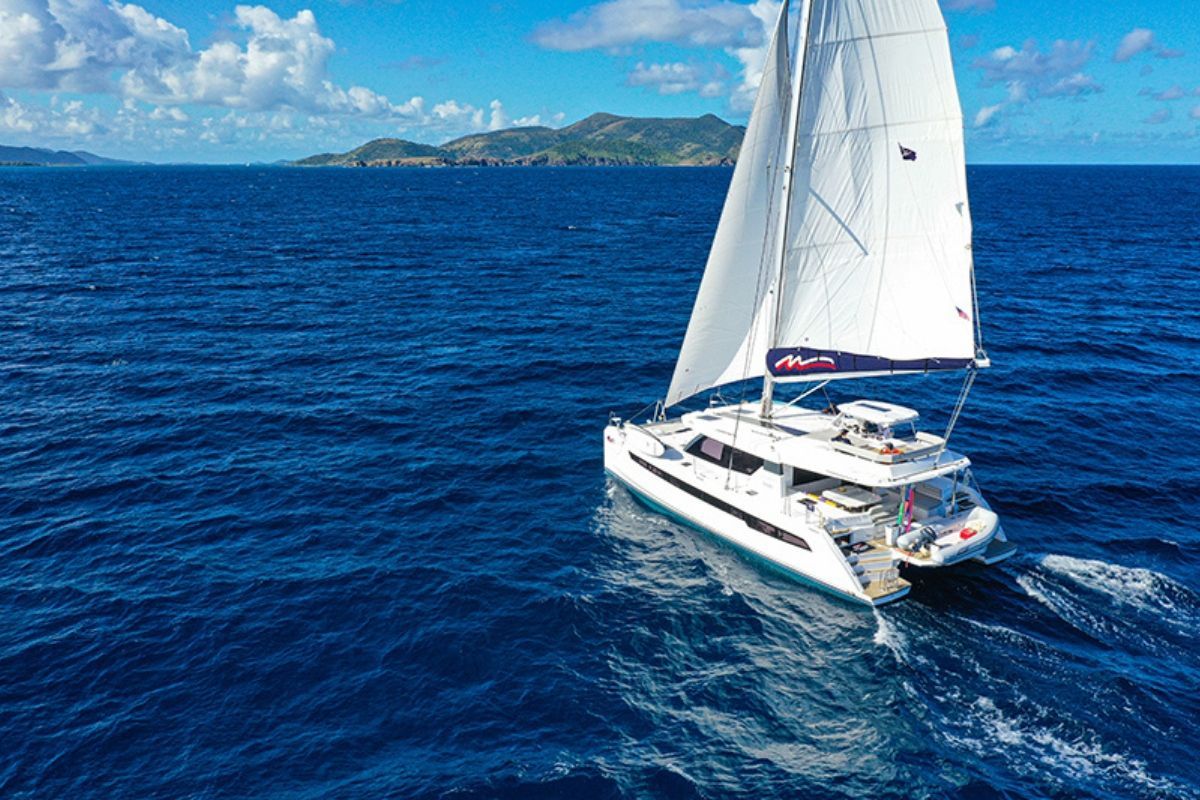 A sailboat is floating on top of a large body of water.