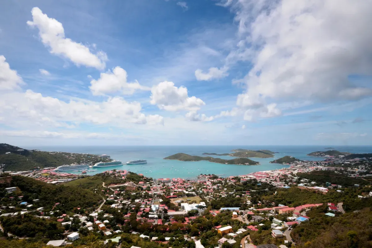 An aerial view of a city with a large body of water in the background.