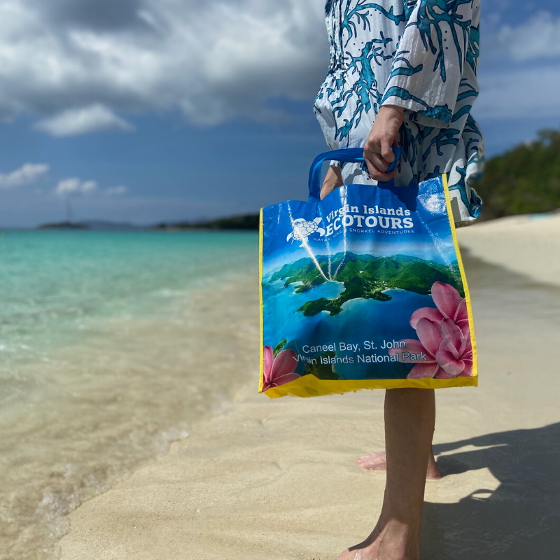 A person holding a bag that says ' hawaii islands tours ' on it