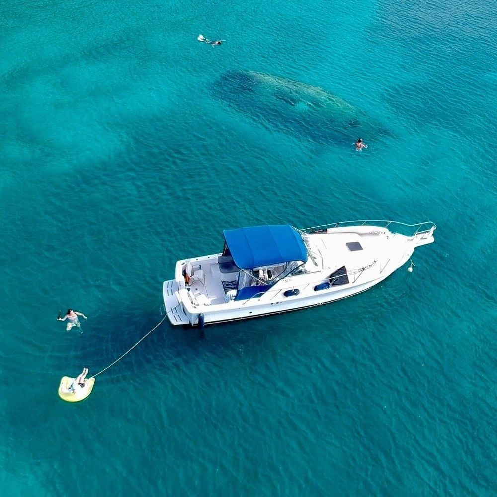 An aerial view of a boat floating on top of a body of water.