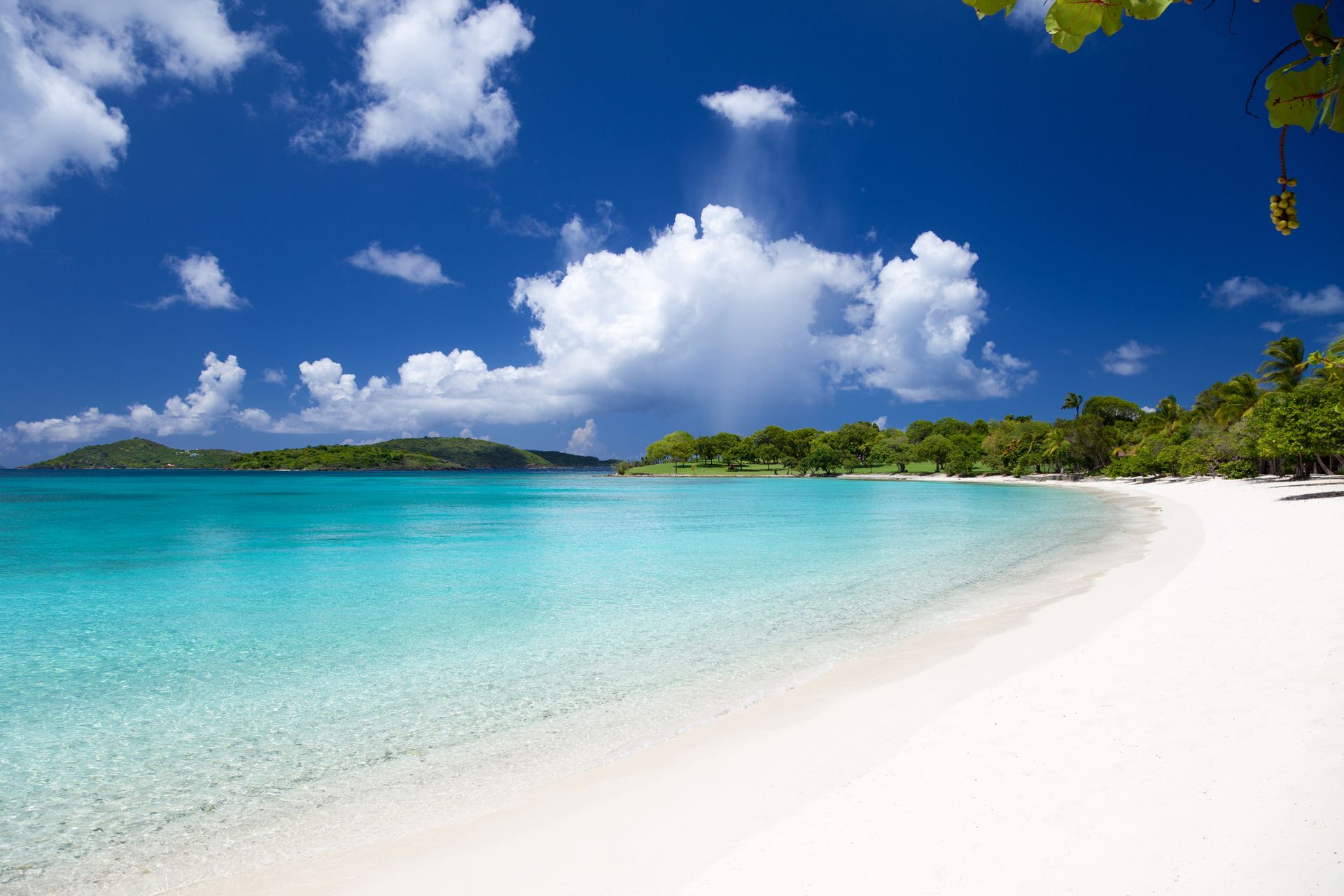 A tropical beach with white sand and turquoise water