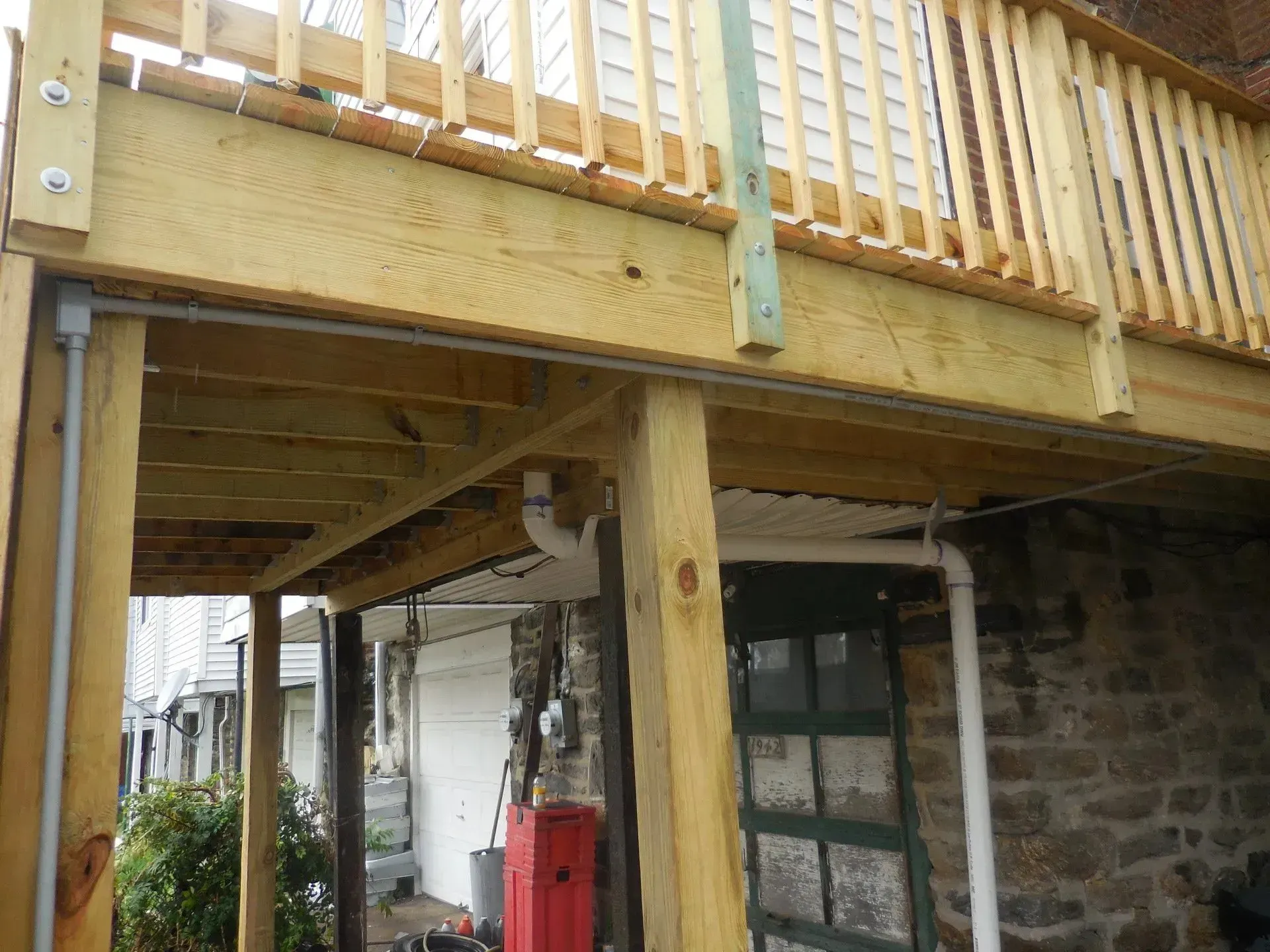 A wooden deck is being built on the side of a house