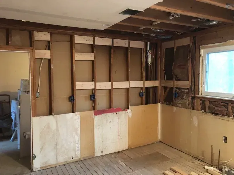 A room with a lot of wooden beams and a window.