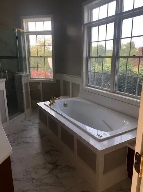 There is a large bathtub in the middle of the bathroom.