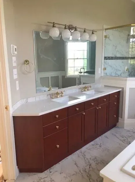 A bathroom with two sinks and a large mirror