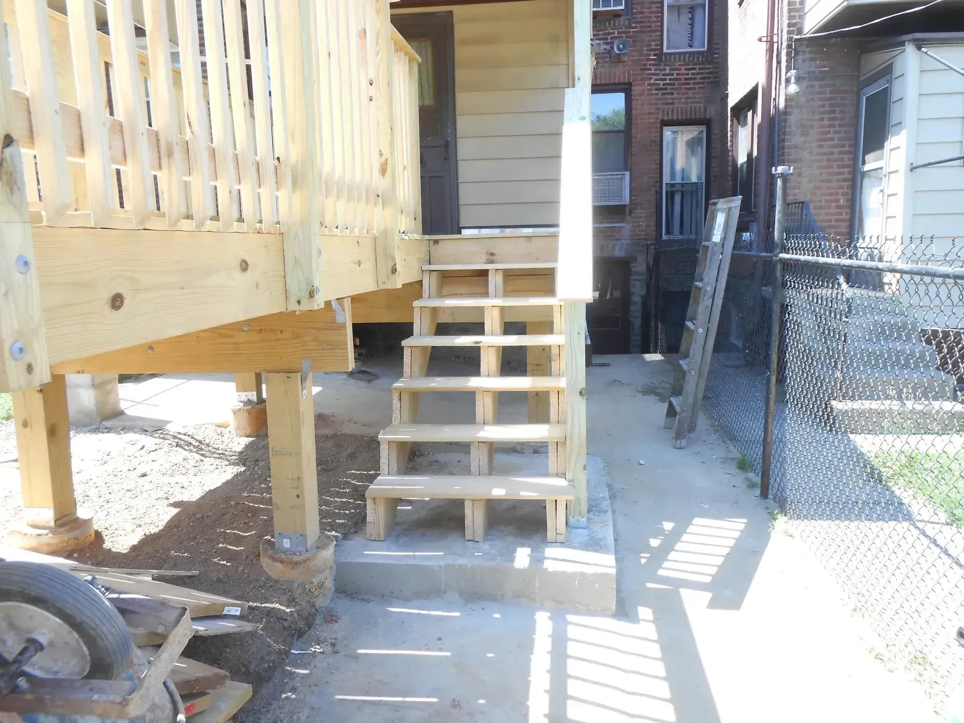 A wooden deck with stairs leading up to it